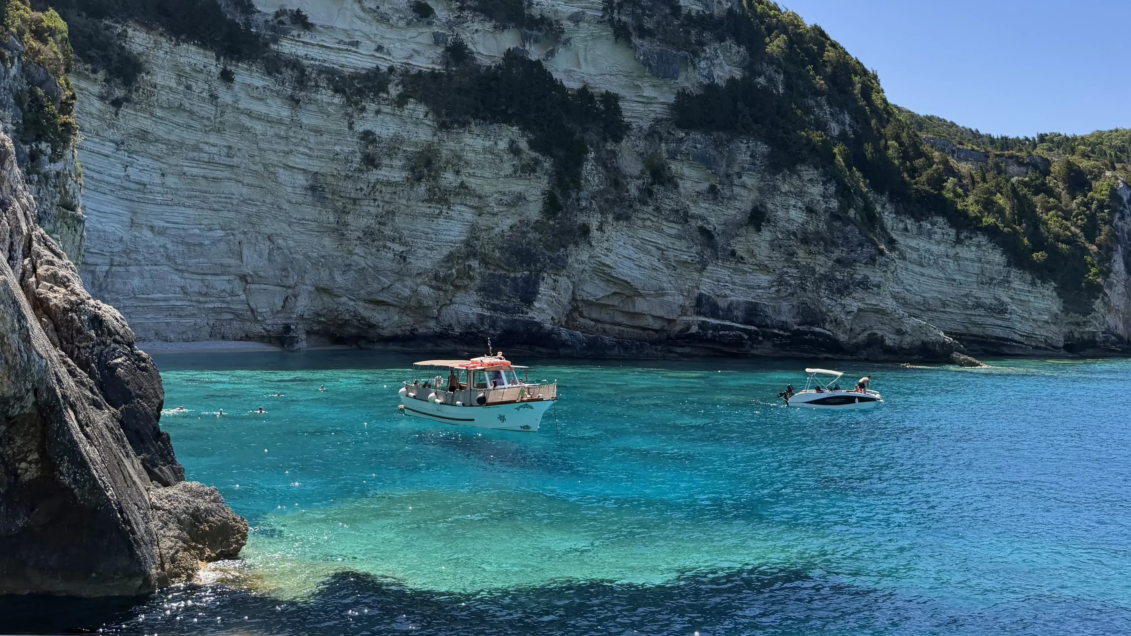 paxos-cove-boats-swimmers-cliffs
